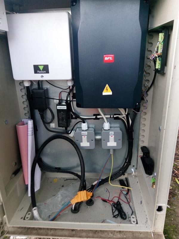 This photo is what we found when we opened the door on this cabinet. No Earth and live wires exposed, also intercom wires just twisted together not soldered