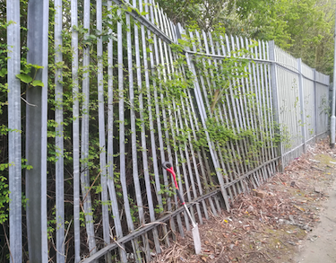Trailer backed into 3M High fence and bent one of the support posts.